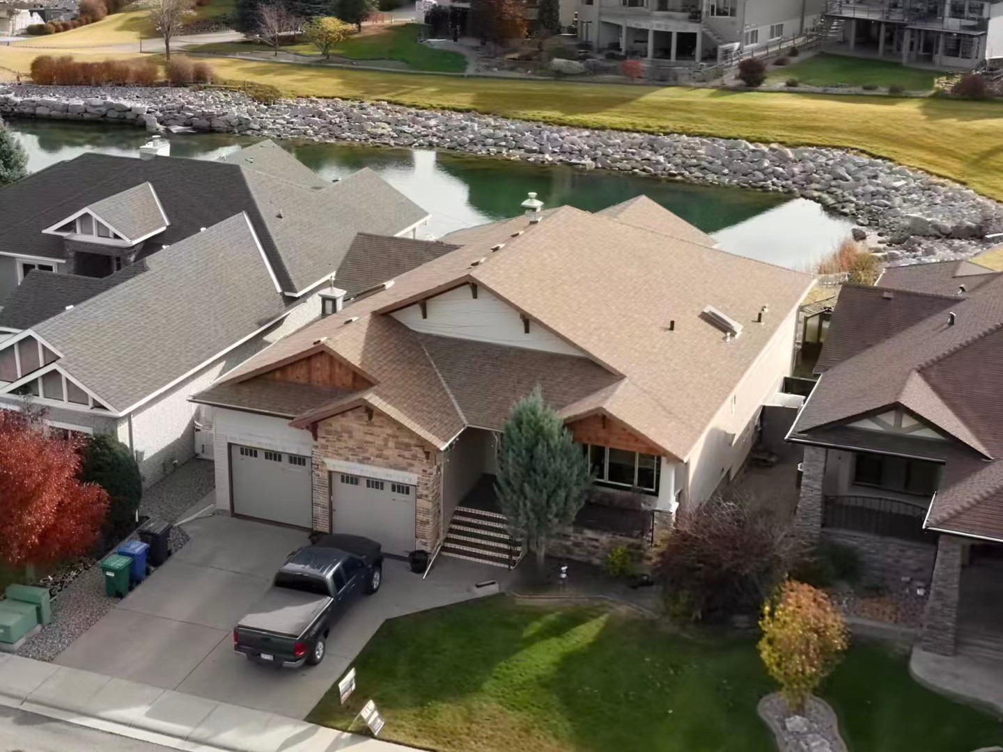 Aerial front exterior and pond setting at 534 Canyon Cove W